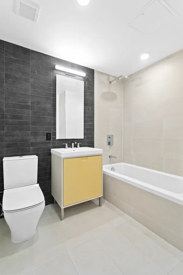 a bathroom with a toilet a sink and bathtub