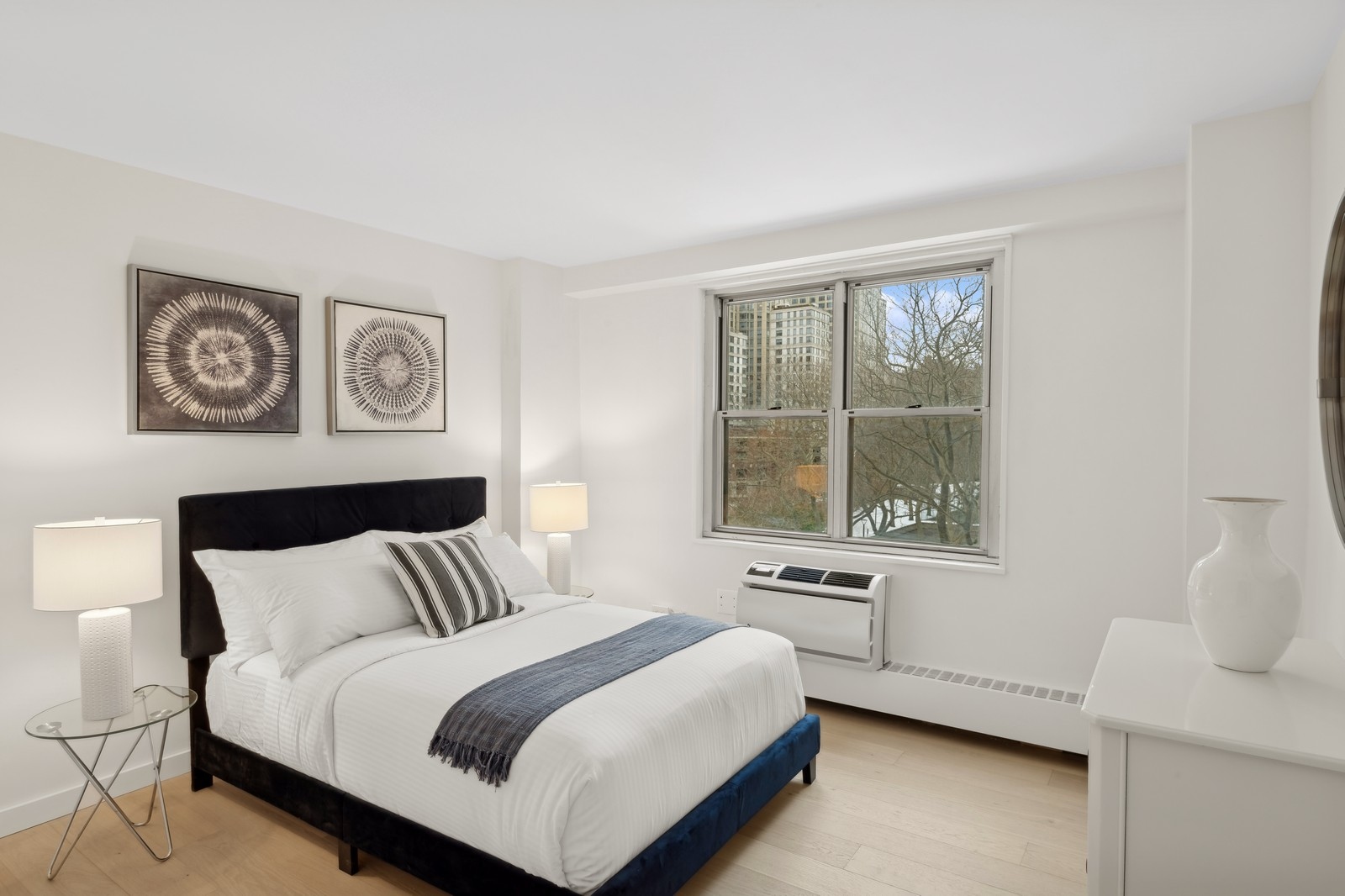 303 West 66th Street, Unit 6BW Manhattan, NY 10023 - Photo 5 of 12 a bedroom with a bed and a window