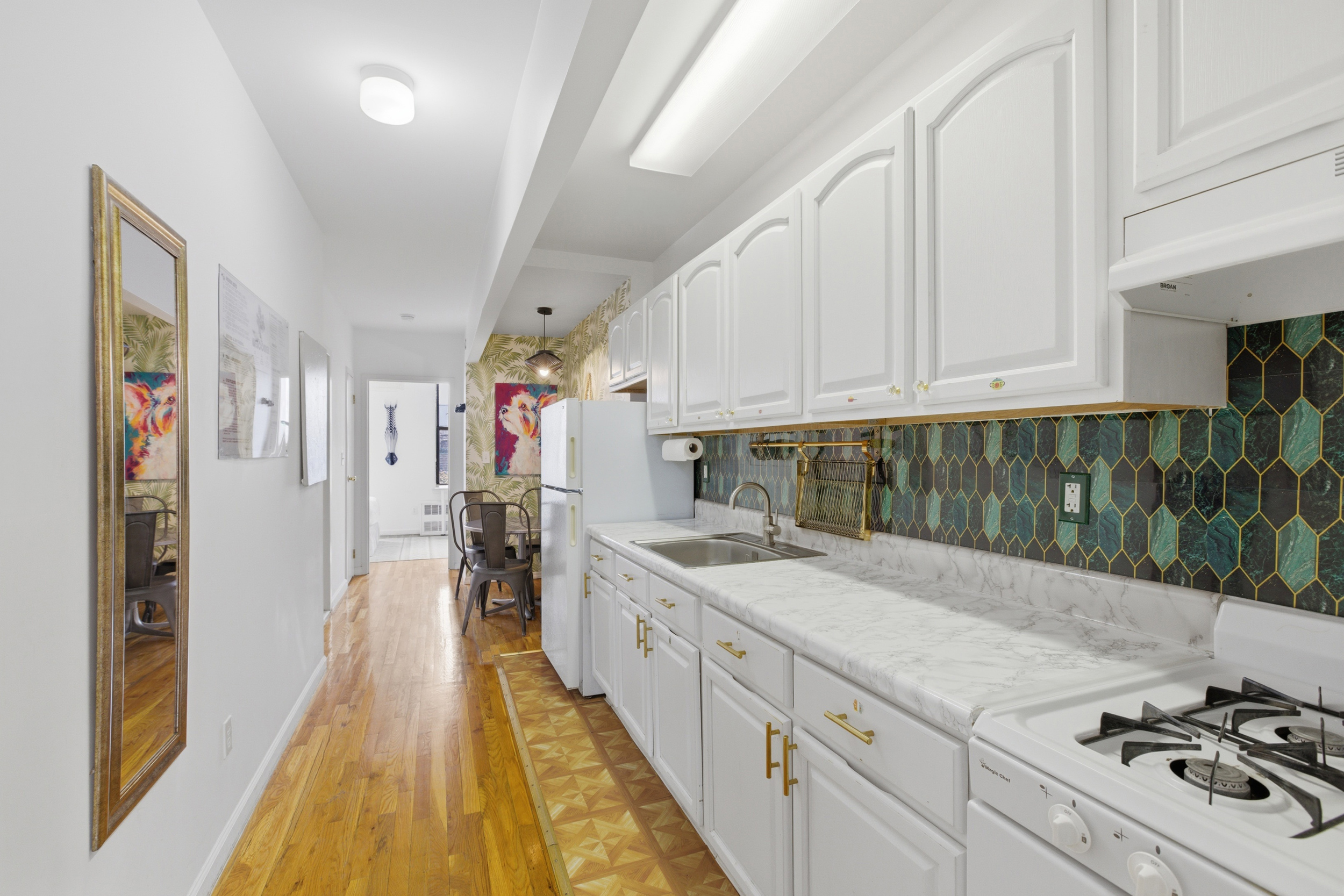 127 West 123rd Street Manhattan, NY 10027 - Photo 17 of 28 a kitchen with a sink stove and cabinets