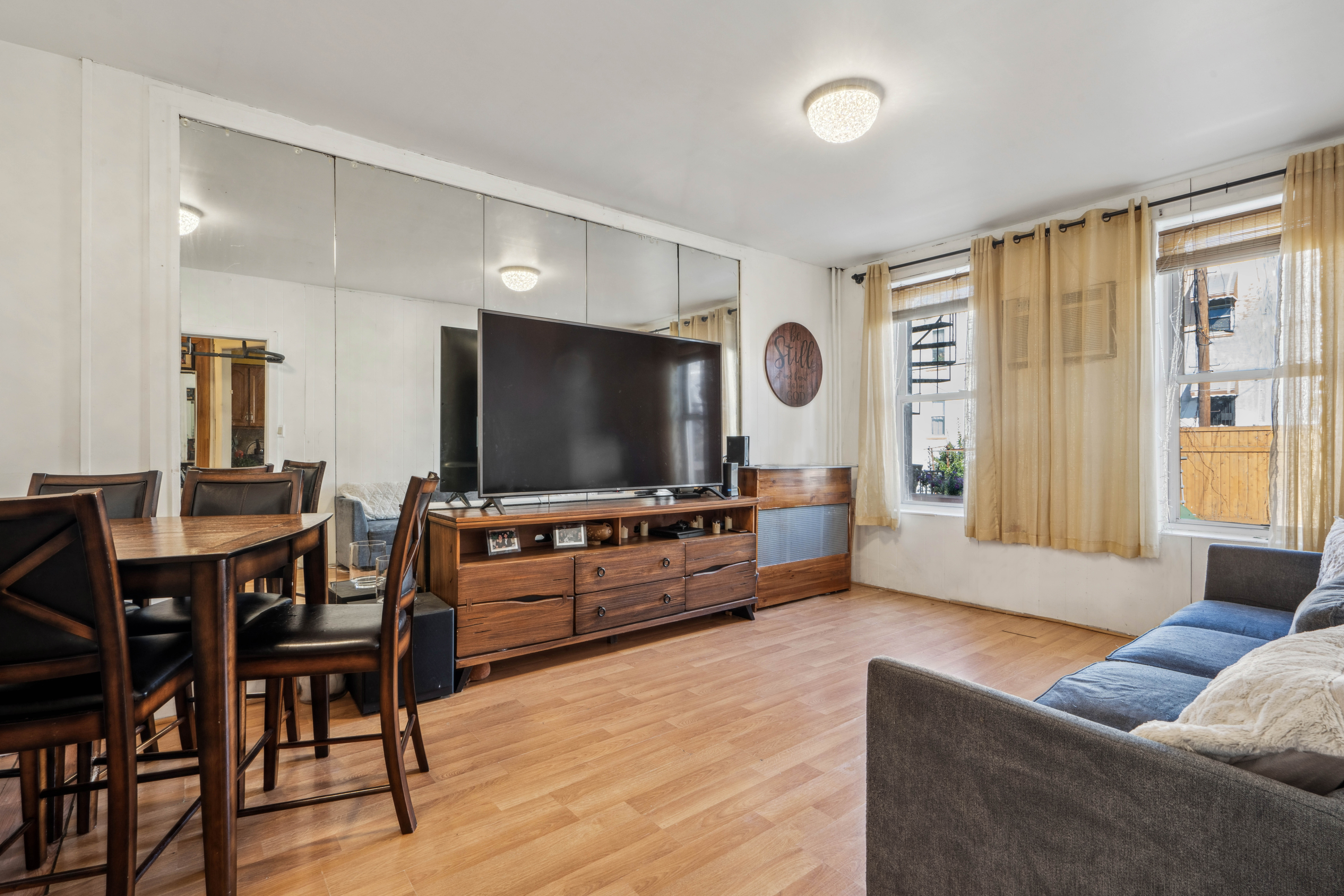 75-27 61st Street Queens, NY 11385 - Photo 7 of 10 a living room with furniture and a flat screen tv