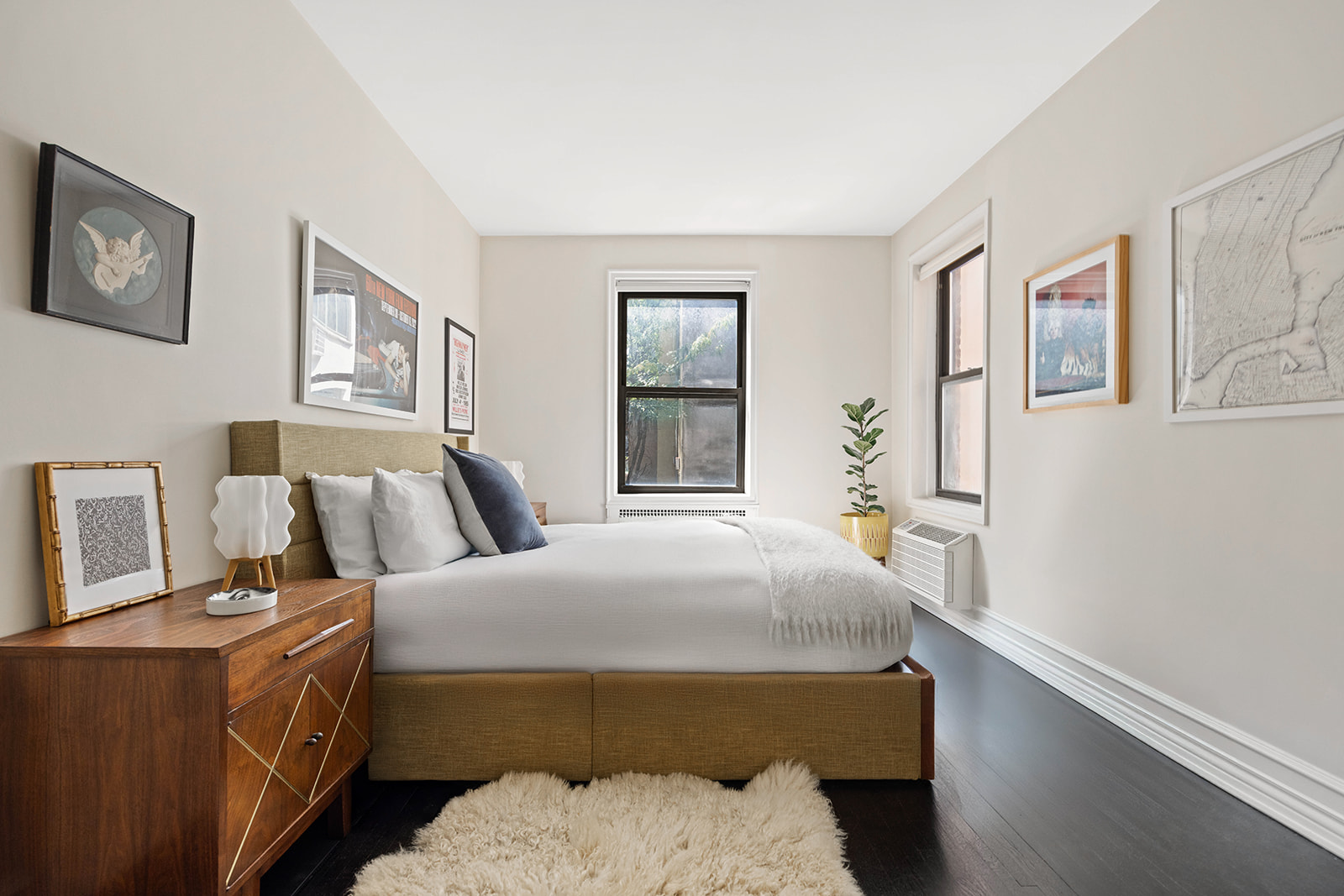 20 Clinton Street, Unit 4E Manhattan, NY 10002 - Photo 6 of 10 a bedroom with a bed and wooden floor