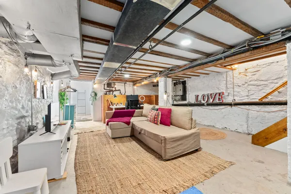 a living room with furniture and a chandelier