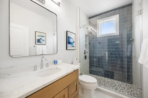 a bathroom with a sink toilet and shower