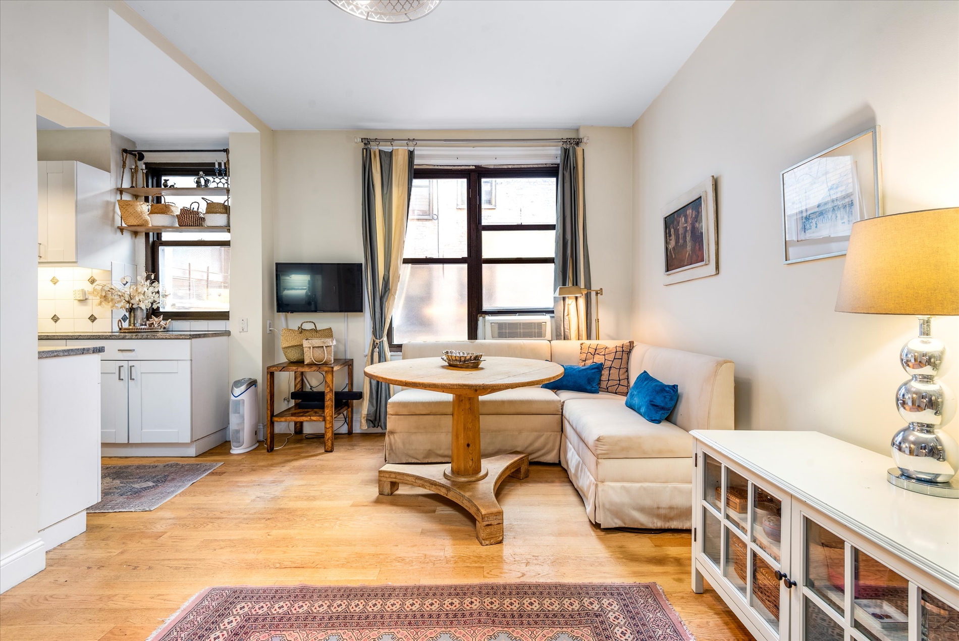 345 East 77th Street, Unit 3C Manhattan, NY 10075 - Photo 10 of 19 a living room with furniture a rug and a table