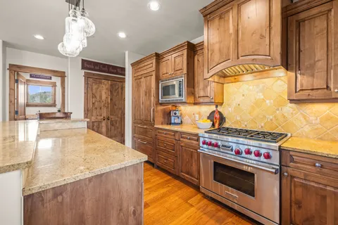 a kitchen with stainless steel appliances granite countertop a stove and a sink