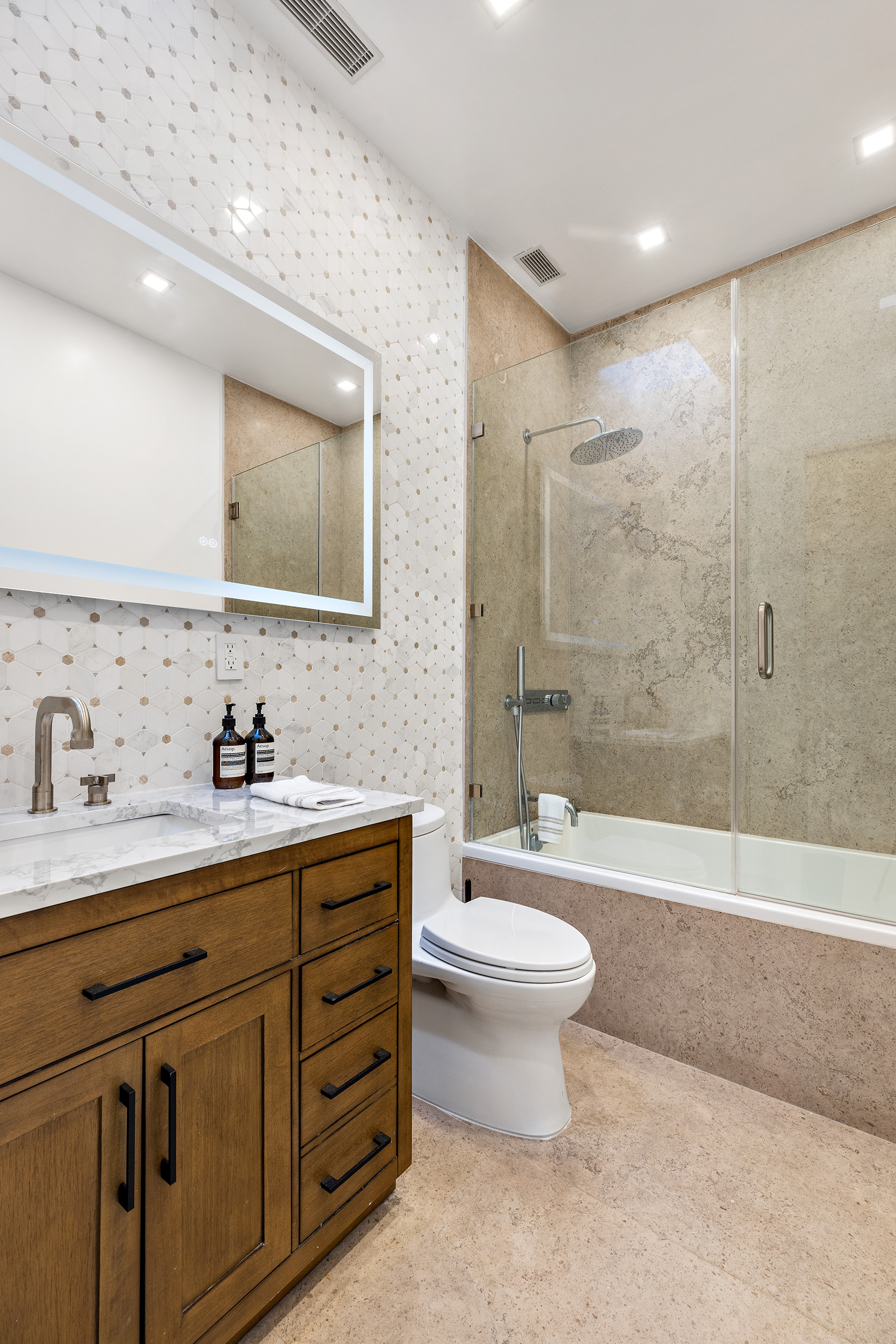 25 East 94th Street Manhattan, NY 10128 - Photo 21 of 33 a bathroom with a double vanity sink mirror double and bathtub