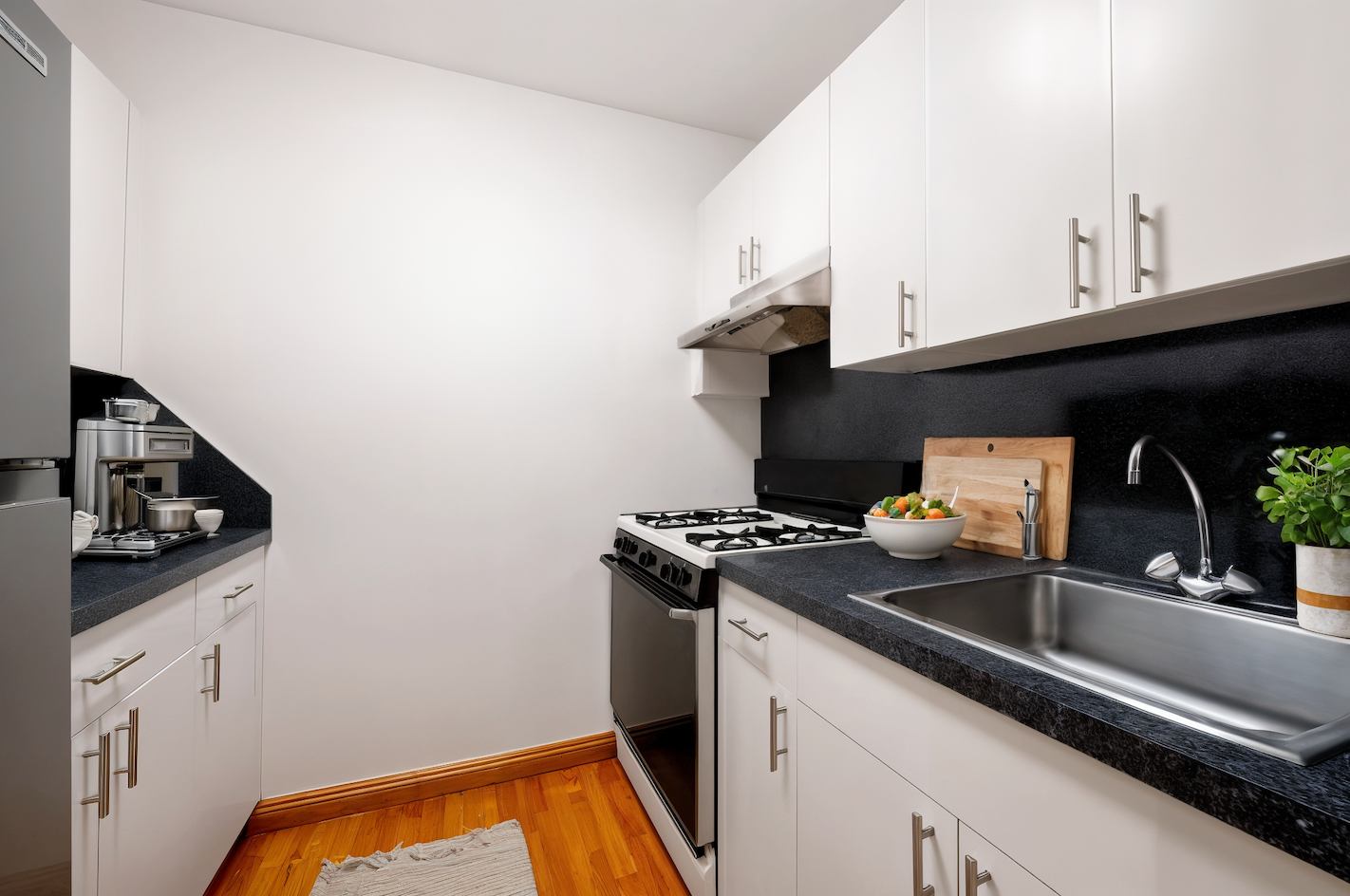 309 East 87th Street, Unit 5A Manhattan, NY 10128 - Photo 5 of 9 a kitchen with a sink and cabinets
