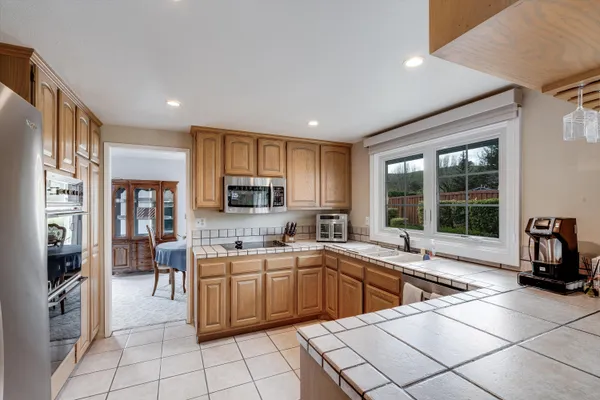 a kitchen with a sink stainless steel appliances and cabinets