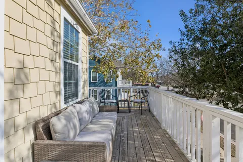 a balcony with furniture and a potted plant