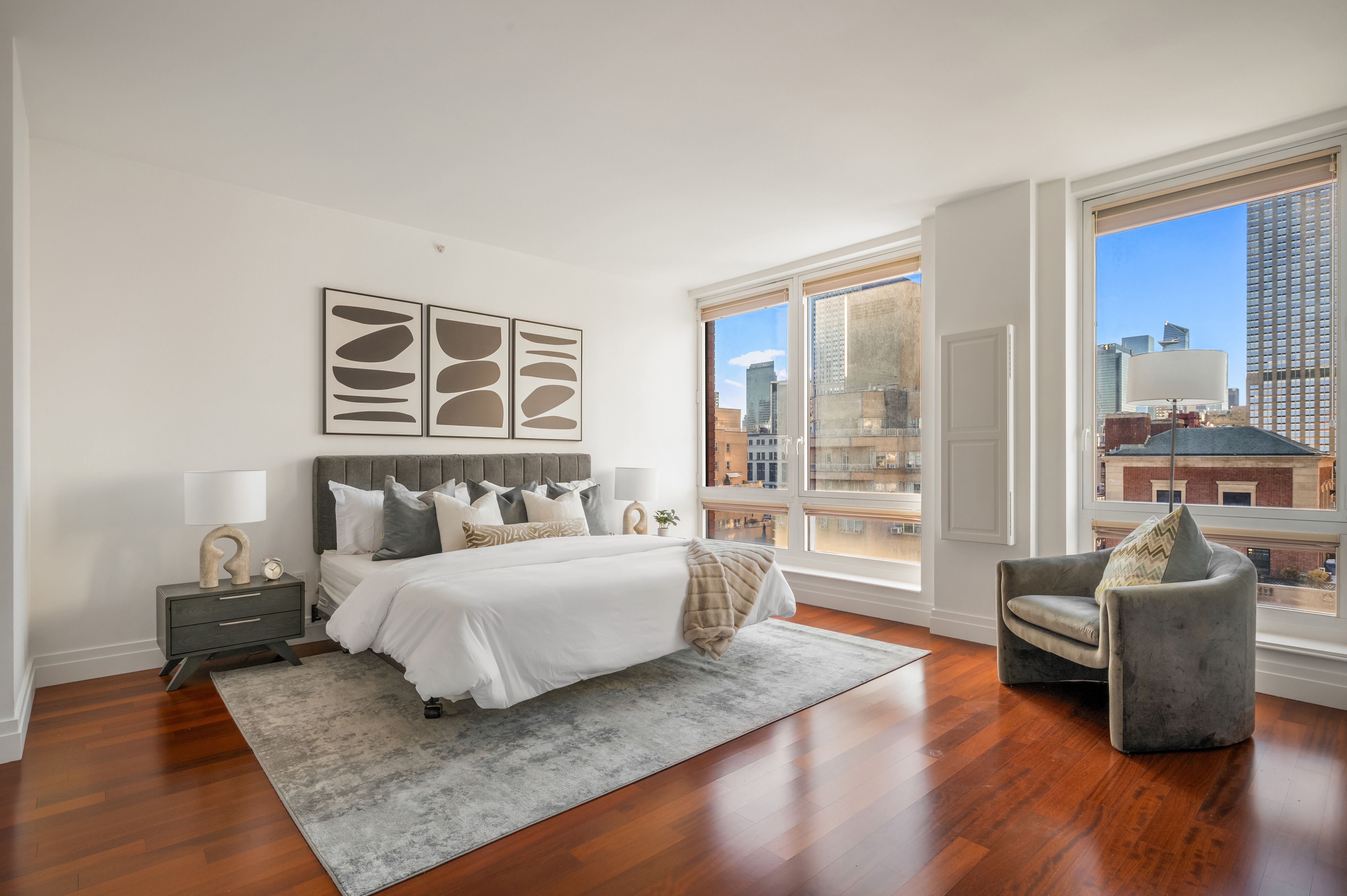 45 Park Avenue, Unit 1801 Manhattan, NY 10016 - Photo 5 of 12 a living room with a bed furniture and a large window