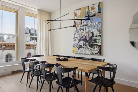 a view of a dining room with furniture and a floor to ceiling window