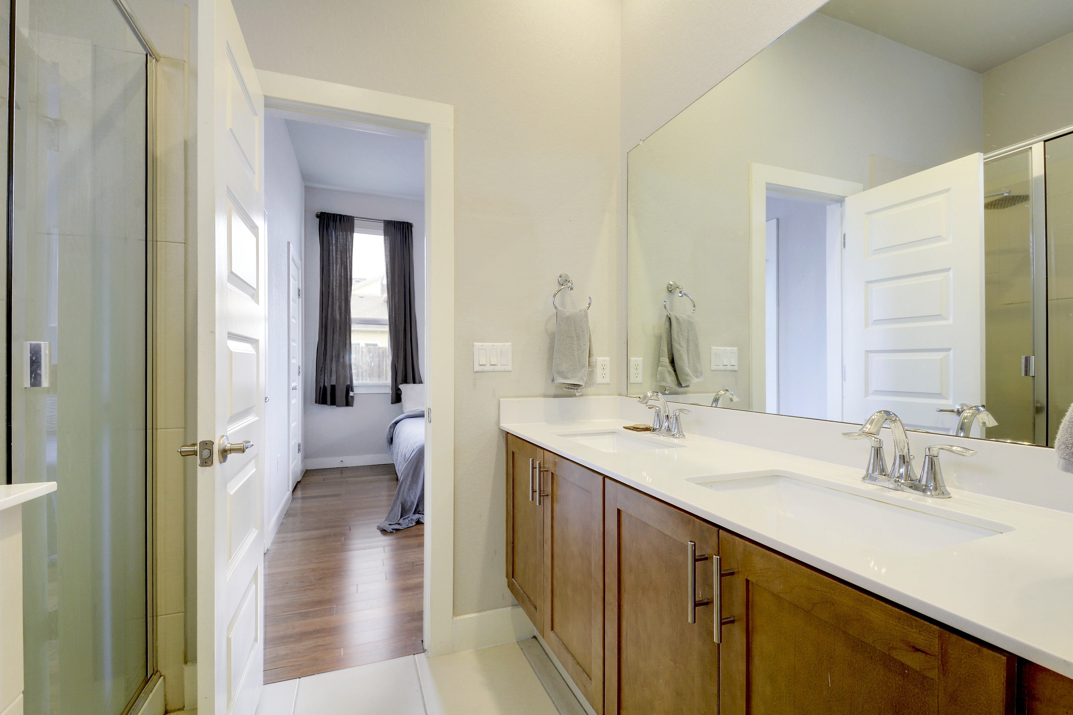 5400 Daimler Drive Austin, TX 78744 - Photo 17 of 27 a en suite bathroom with a sink mirror and a toilet