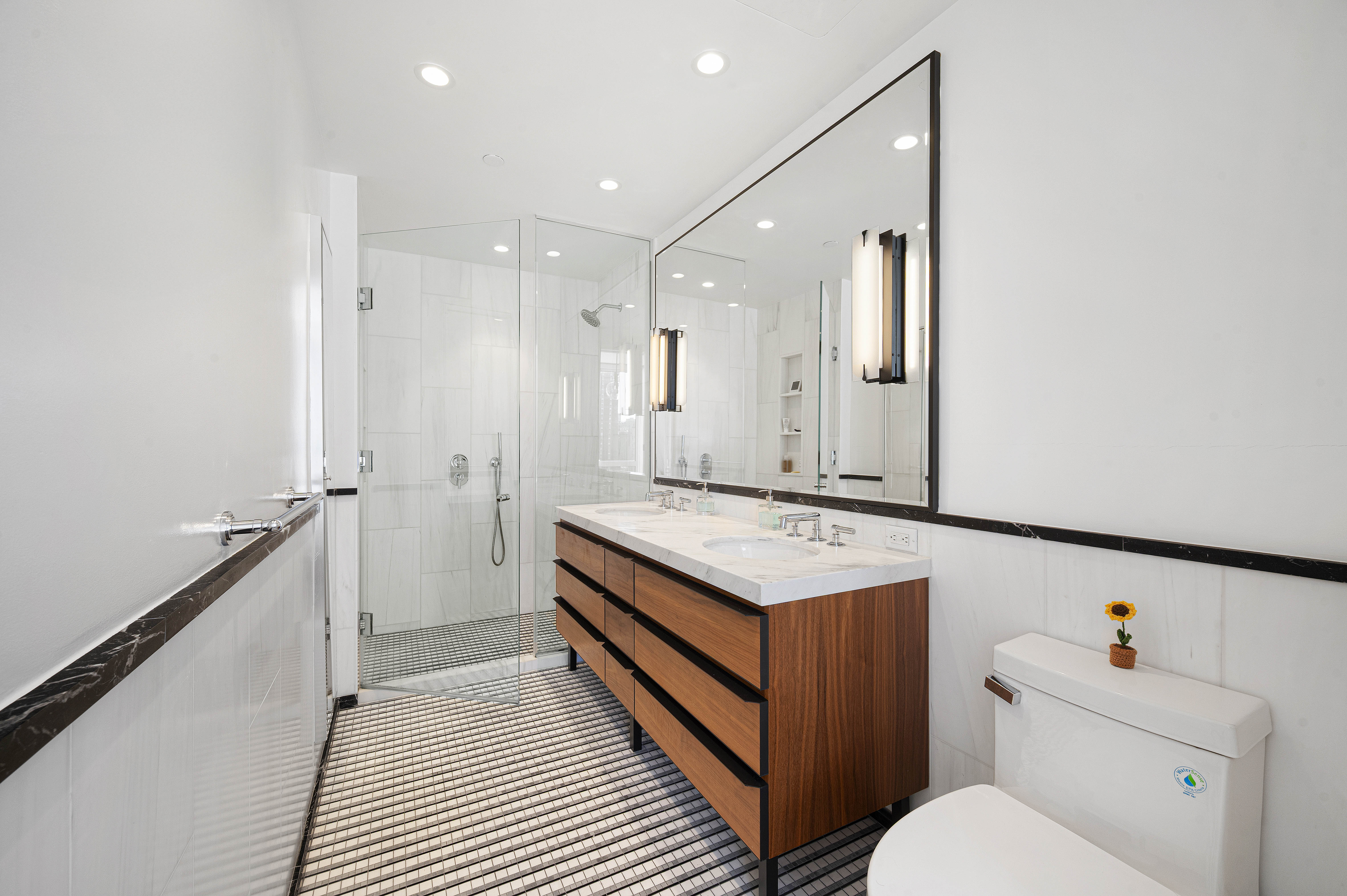 368 3rd Avenue, Unit 11A Manhattan, NY 10016 - Photo 6 of 17 a bathroom with a granite countertop sink mirror vanity and toilet
