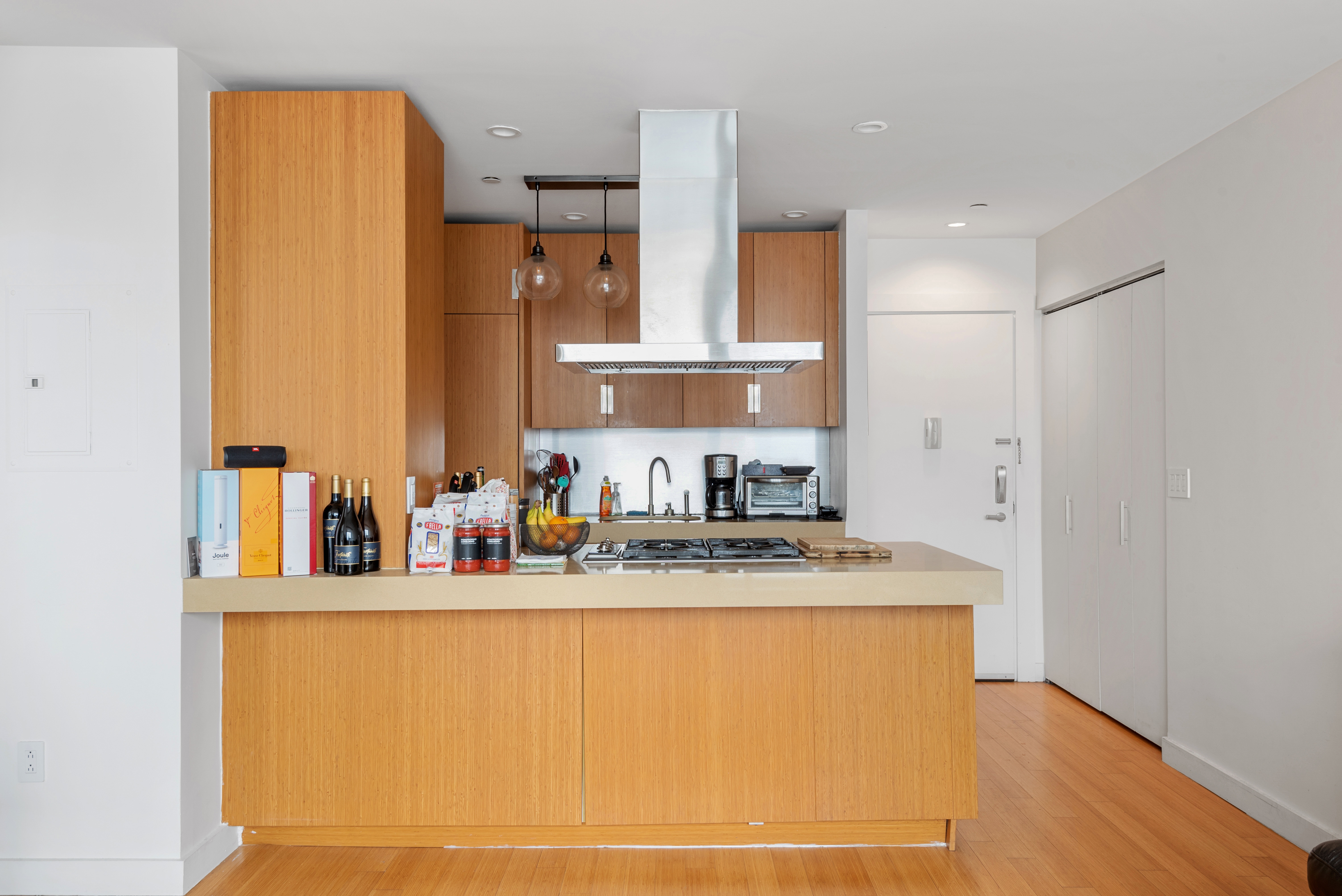 450 West 17th Street, Unit 1811 Manhattan, NY 10011 - Photo 4 of 14 a bathroom with a granite countertop sink a mirror and shower
