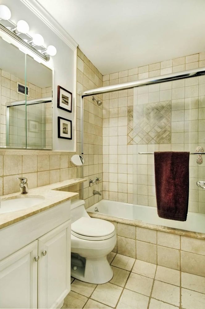 200 East 90th Street, Unit 7A Manhattan, NY 10128 - Photo 4 of 7 a bathroom with a sink a toilet and shower