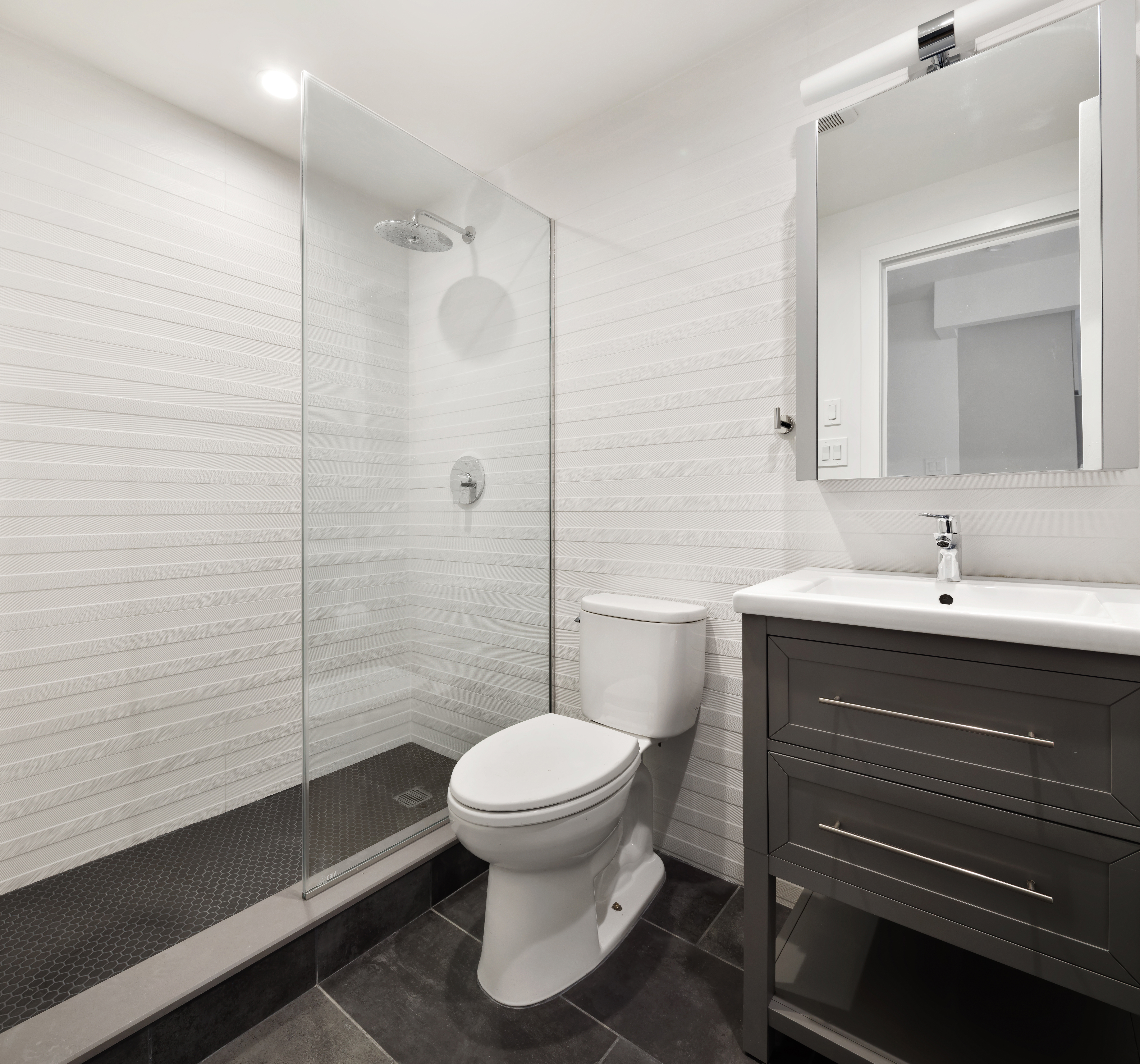 45-08 11th Street, Unit GARDEN Queens, NY 11101 - Photo 6 of 9 a bathroom with a sink toilet and shower