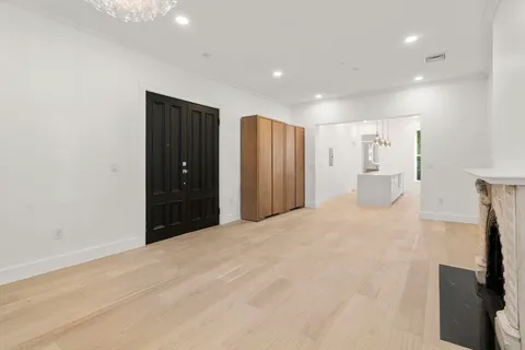 an empty room with windows and fireplace