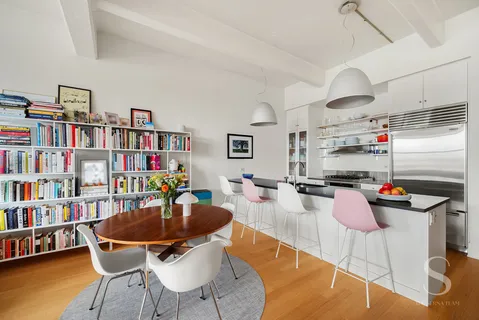a dining room with furniture and a book shelf