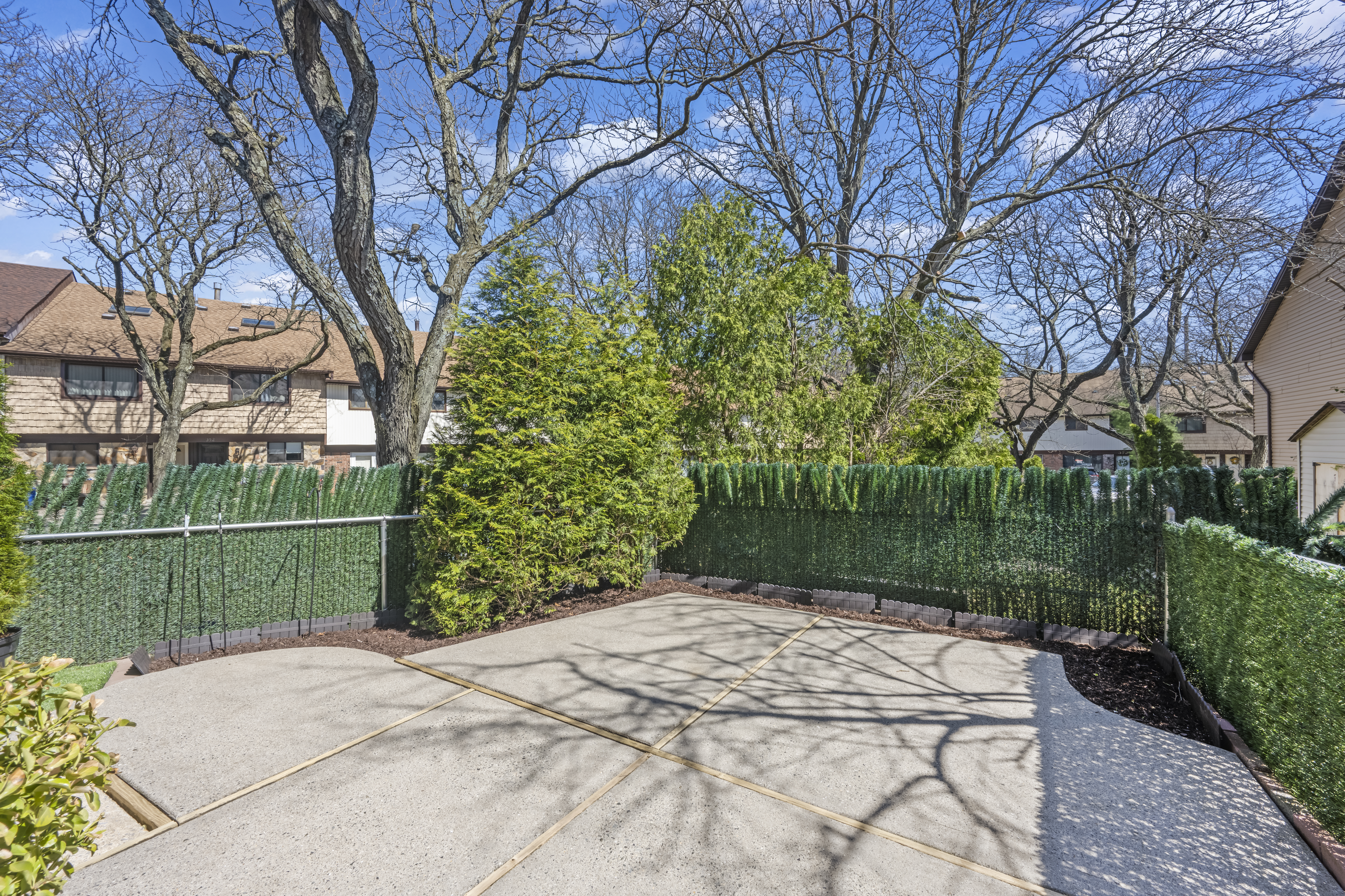 15 Hickory Circle Staten Island, NY 10312 - Photo 29 of 40 a backyard of a house with lots of green space and fountain
