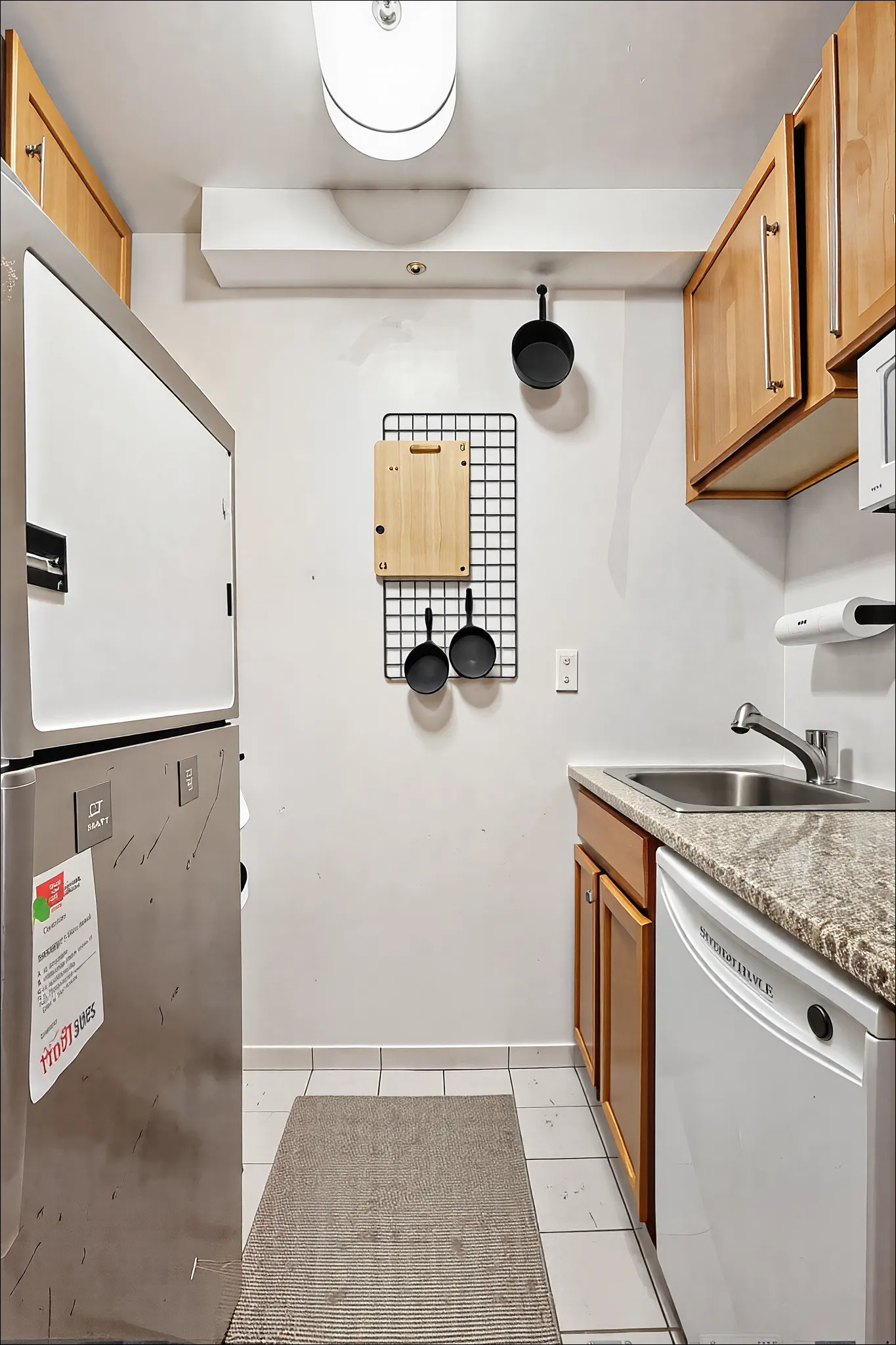 350 West 50th Street, Unit 2DD Manhattan, NY 10019 - Photo 4 of 7 a bathroom with a granite countertop sink a toilet and mirror