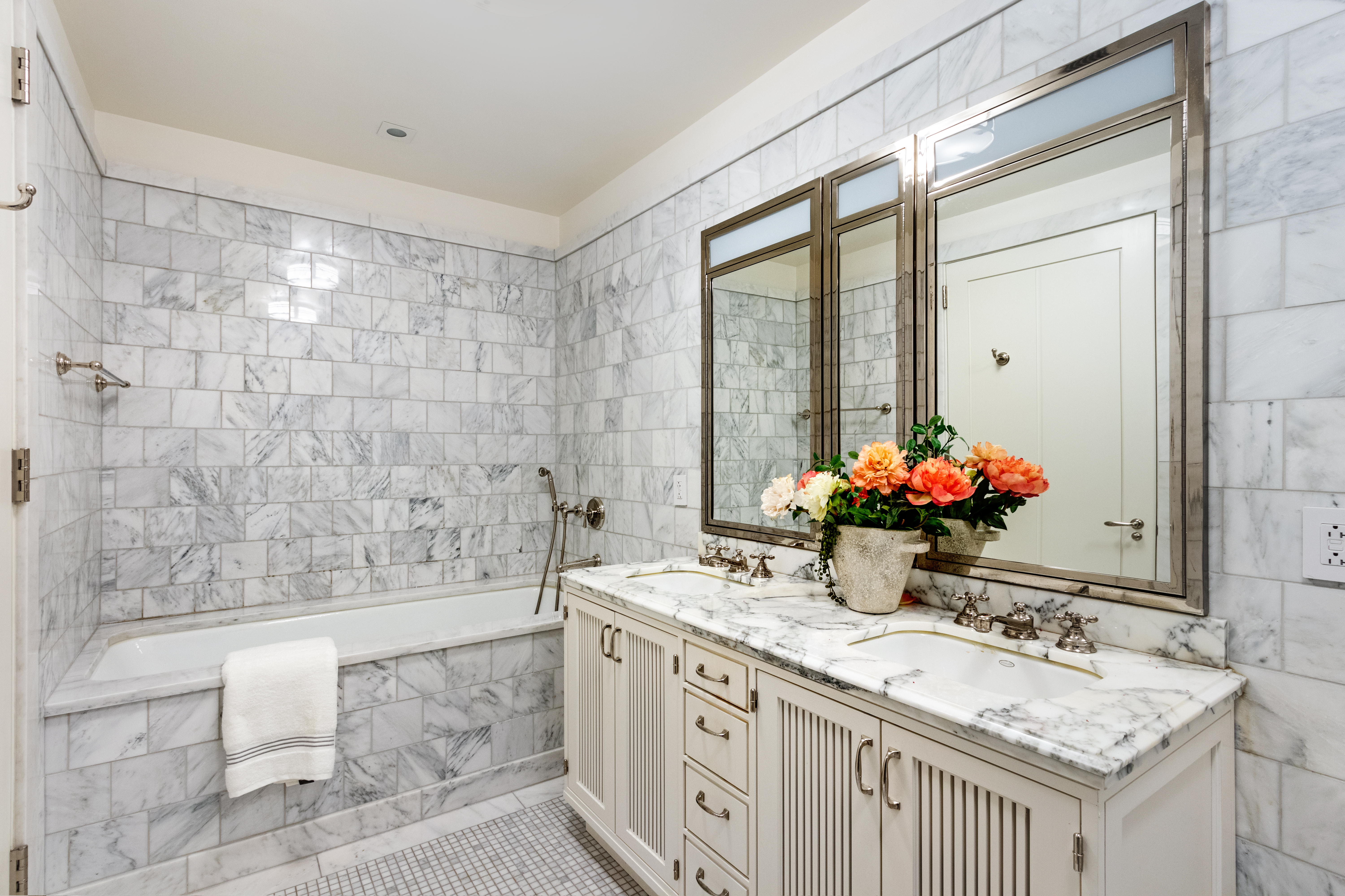 160 West 12th Street, Unit 56 Manhattan, NY 10011 - Photo 6 of 18 a bathroom with a granite countertop sink a large mirror and a bathtub