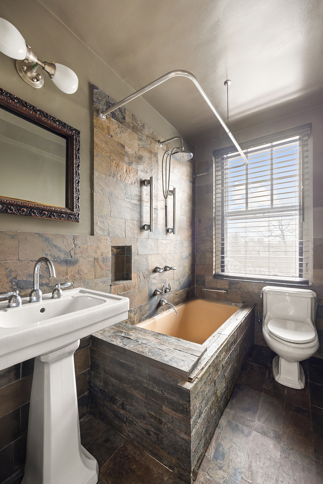 5 Riverside Drive, Unit 3B Manhattan, NY 10023 - Photo 10 of 14 a bathroom with a double vanity sink a mirror and a bathtub