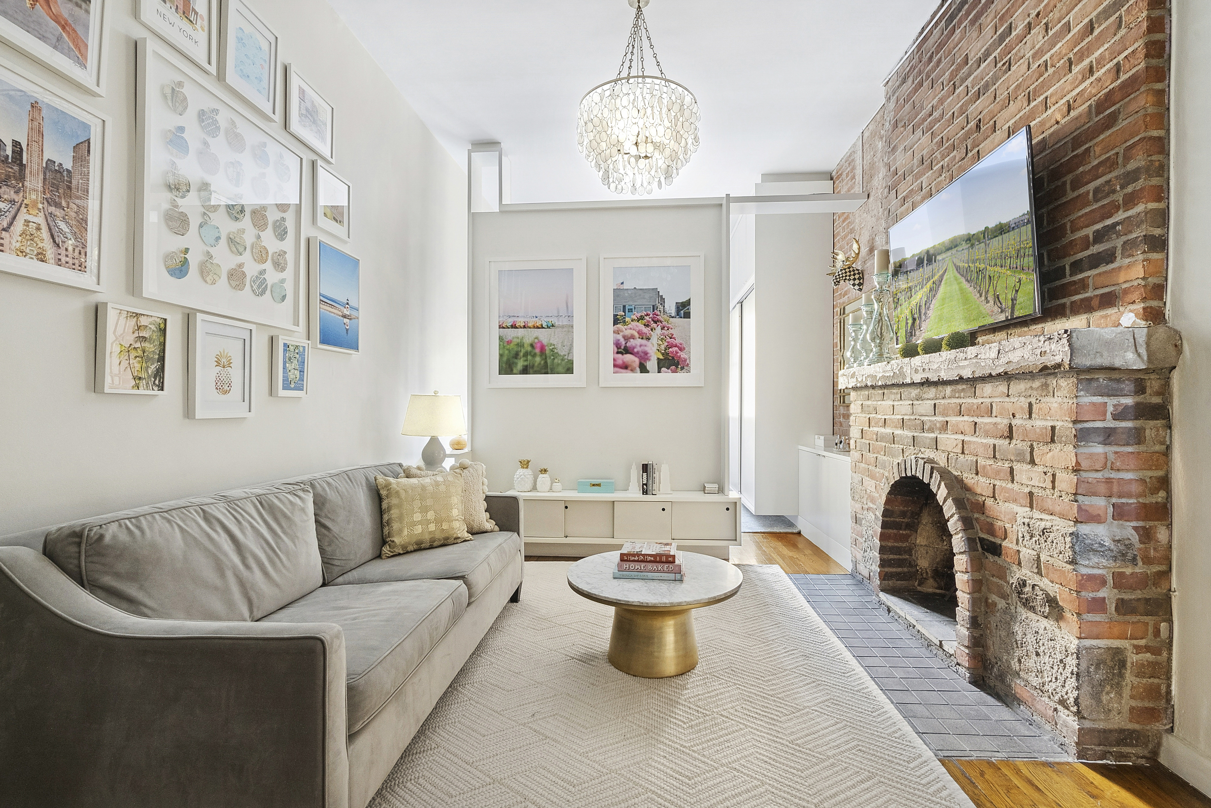 252 West 20th Street, Unit 2B Manhattan, NY 10011 - Photo 1 of 6 a living room with furniture a fireplace and a flat screen tv