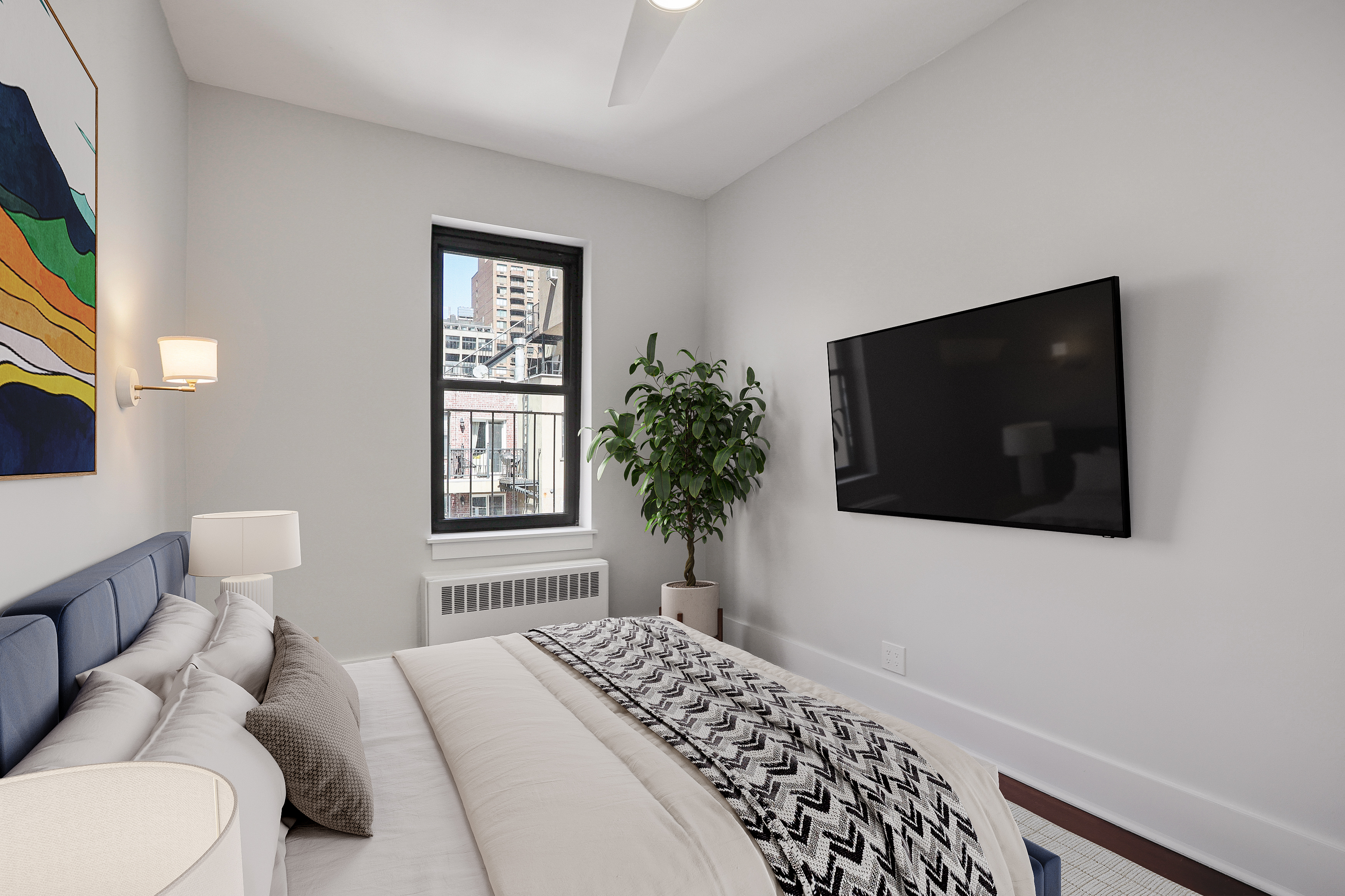 133 East 30th Street, Unit PH5B Manhattan, NY 10016 - Photo 5 of 24 a bedroom with a bed and a flat screen tv