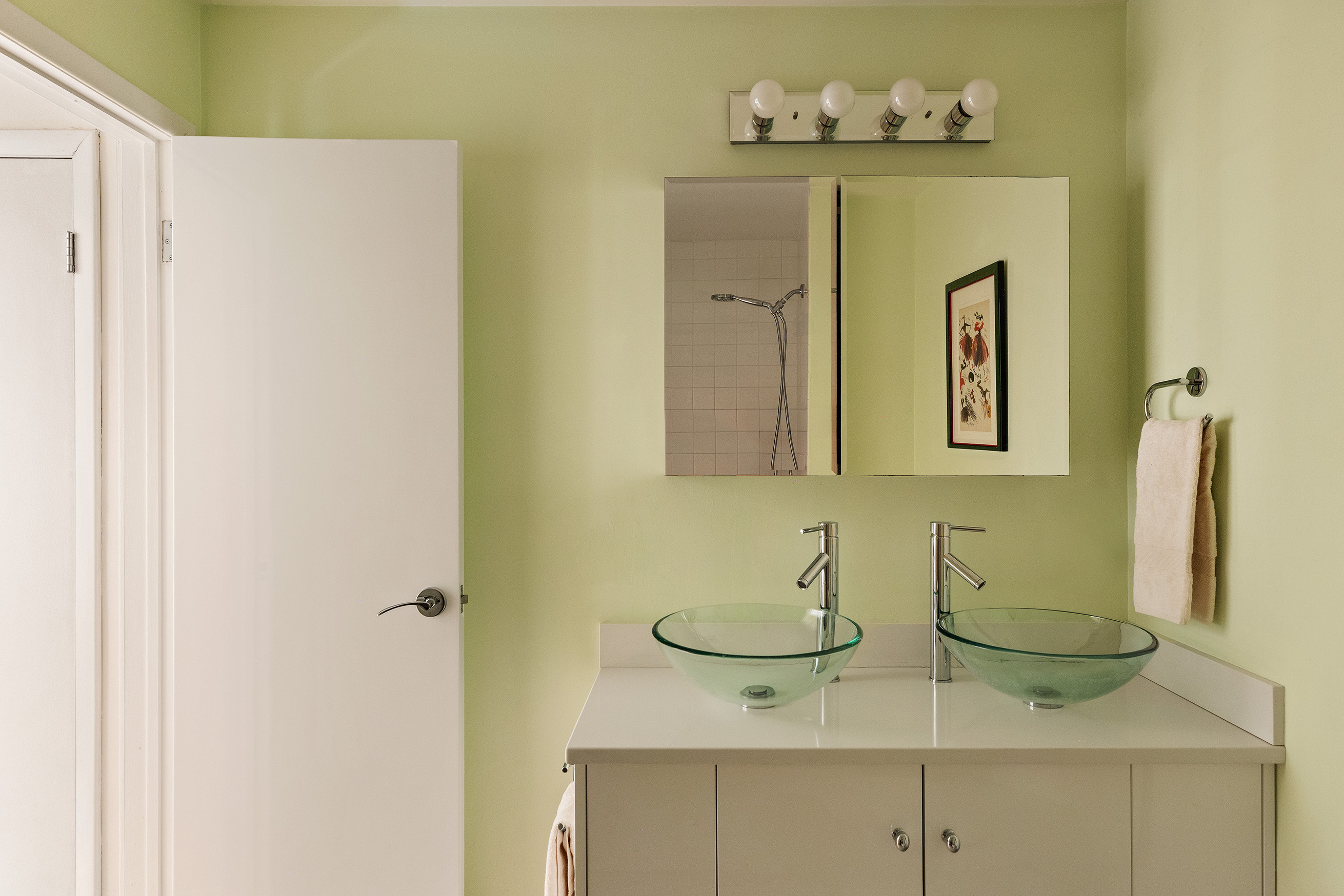 21 East 22nd Street, Unit 2K Manhattan, NY 10010 - Photo 8 of 13 a bathroom with a sink mirror and vanity