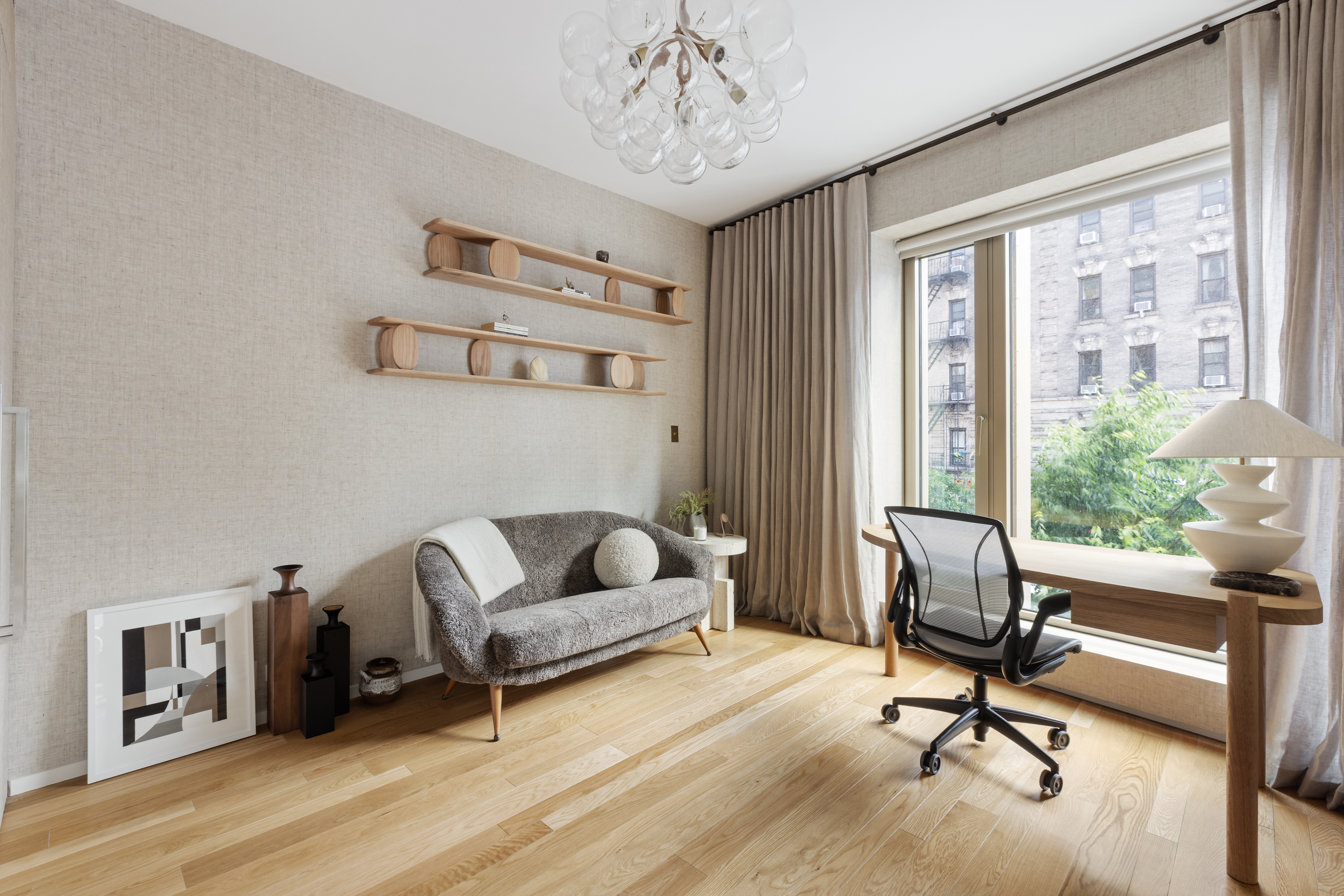 75 Kenmare Street, Unit 2D Manhattan, NY 10012 - Photo 12 of 15 a living room with furniture and a window