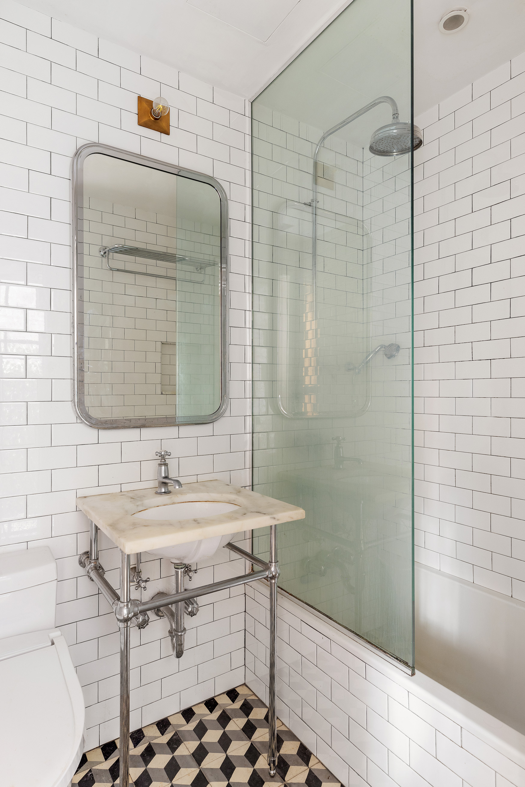 221 West 21st Street, Unit 1C Manhattan, NY 10011 - Photo 8 of 9 a bathroom with a sink and a mirror