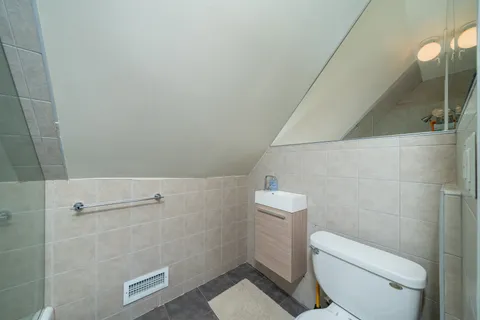 a white toilet sitting next to a bathroom sink