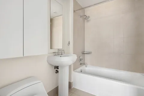 a bathroom with a sink a shower and bathtub