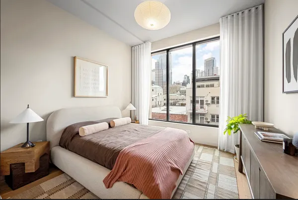 a spacious bedroom with a bed and a window