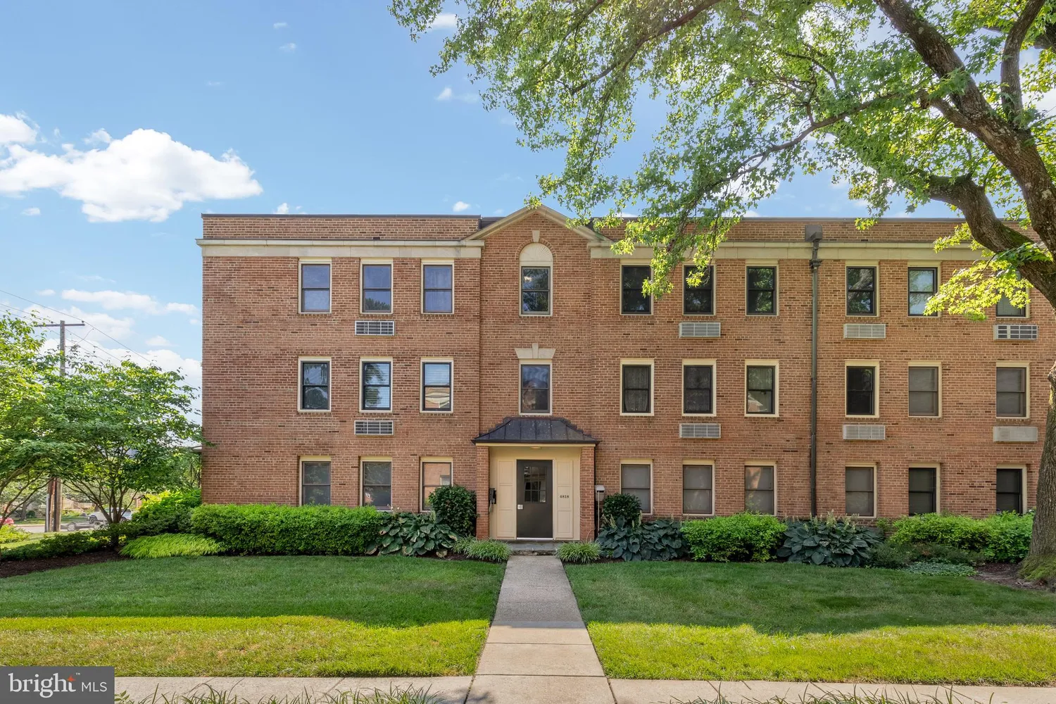 a front view of a brick house with a yard
