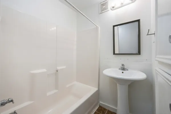 a bathroom with a sink a mirror and a bathtub
