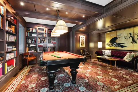 a room with furniture pool table and flat screen tv