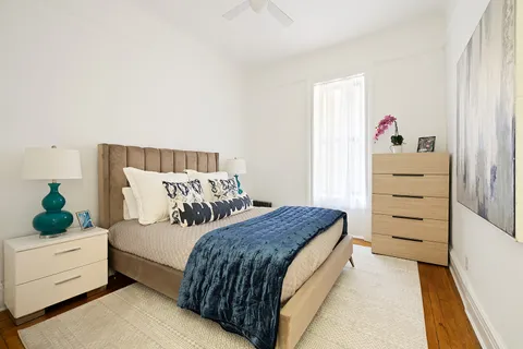 a bedroom with a bed and a dresser