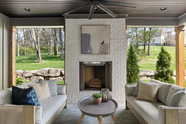 a backyard of a house with lots of trees and entertaining space