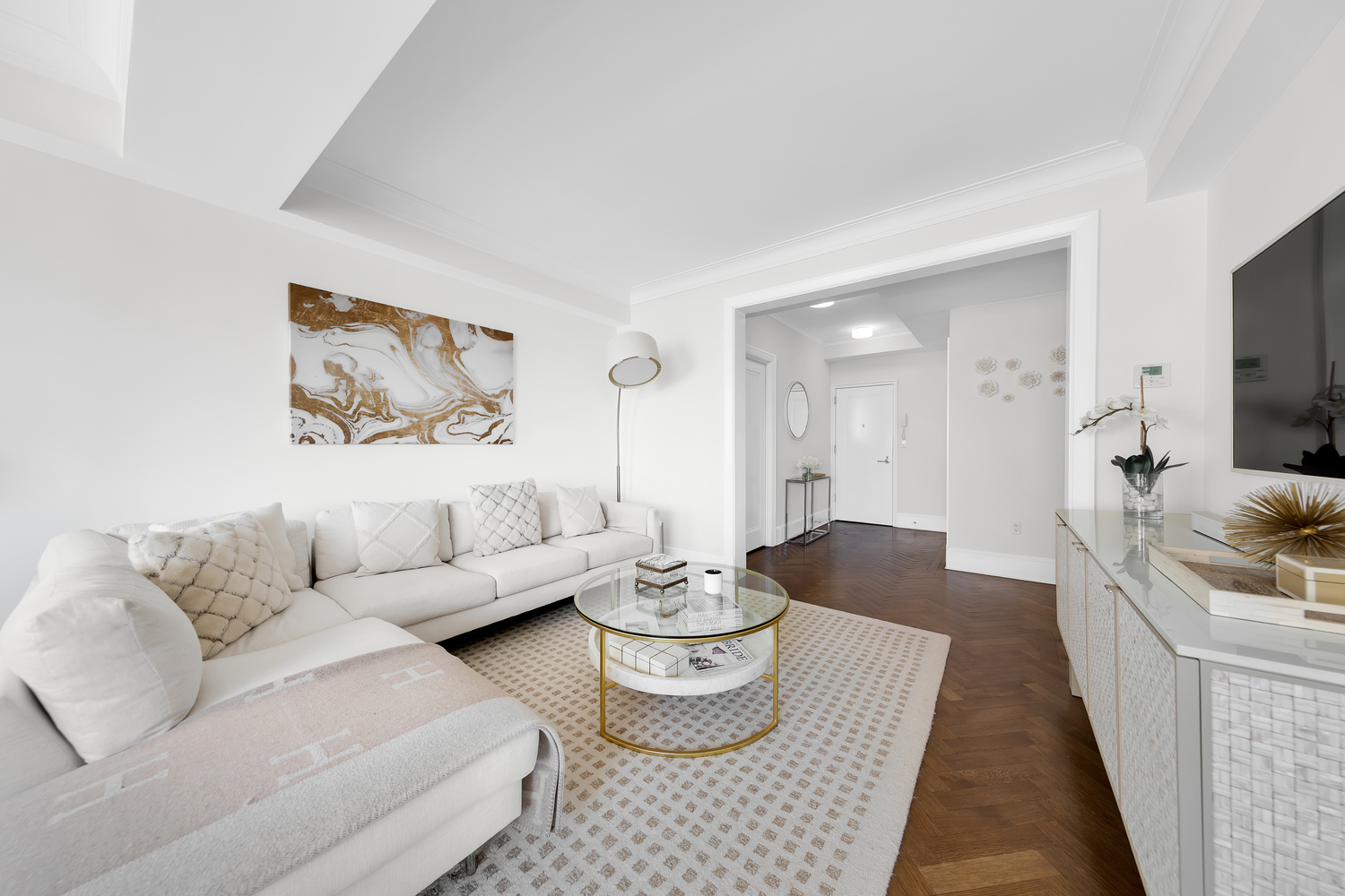 530 Park Avenue, Unit 19G Manhattan, NY 10065 - Photo 2 of 11 a living room with furniture and a flat screen tv