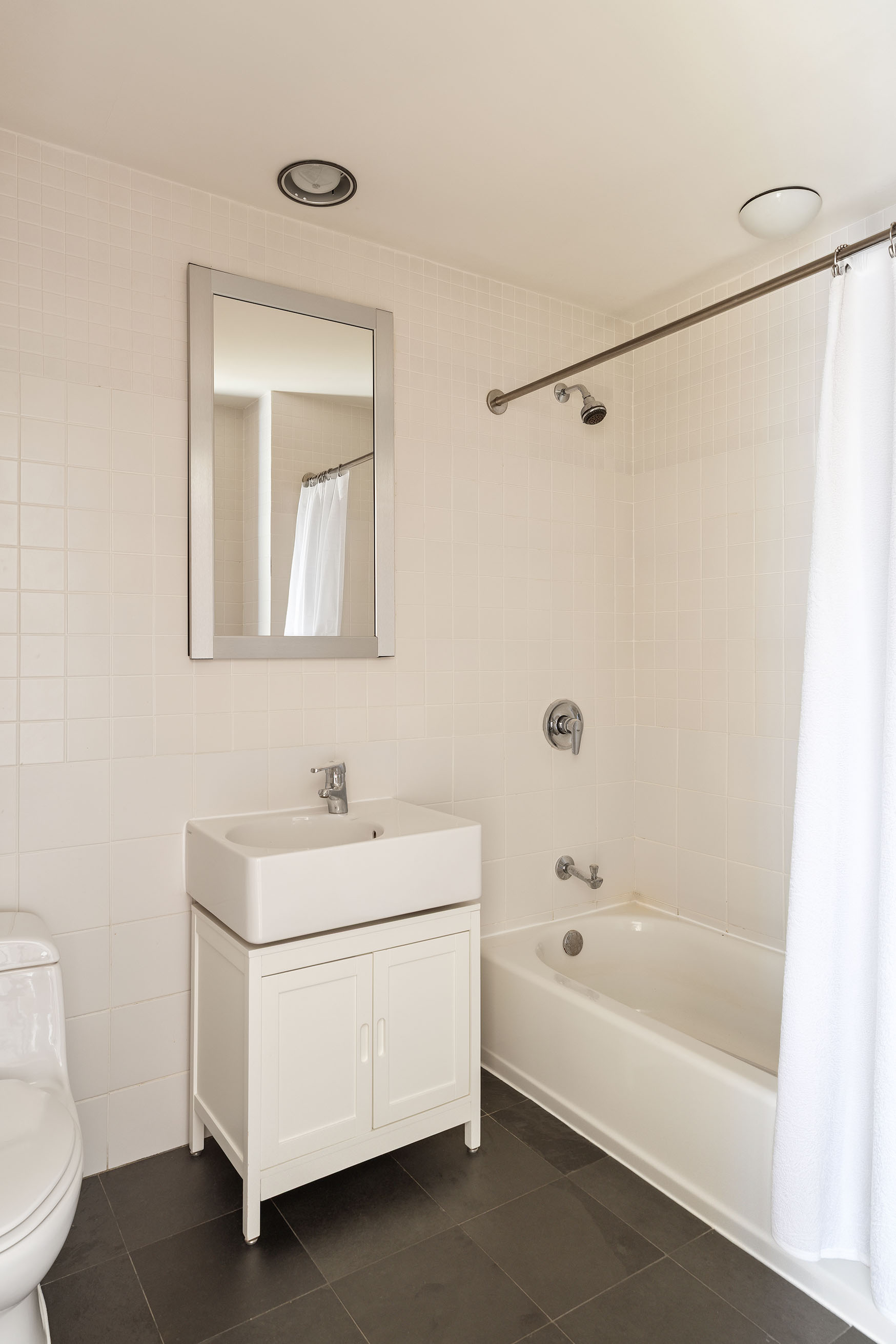 80 Chambers Street, Unit 11A Manhattan, NY 10007 - Photo 12 of 24 a bathroom with a sink a toilet and bathtub
