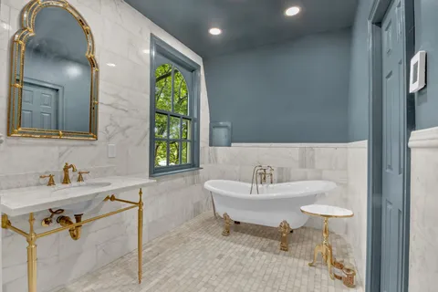 a bedroom with a bed and a mirror