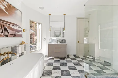 a bathroom with a sink a toilet a shower and a bathtub