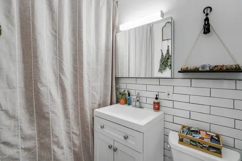 a bathroom with a sink and a window