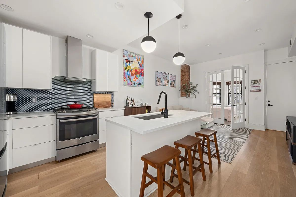 a kitchen that has a lot of cabinets in it and white cabinets