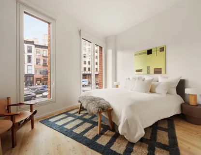 a spacious bedroom with a bed and a window