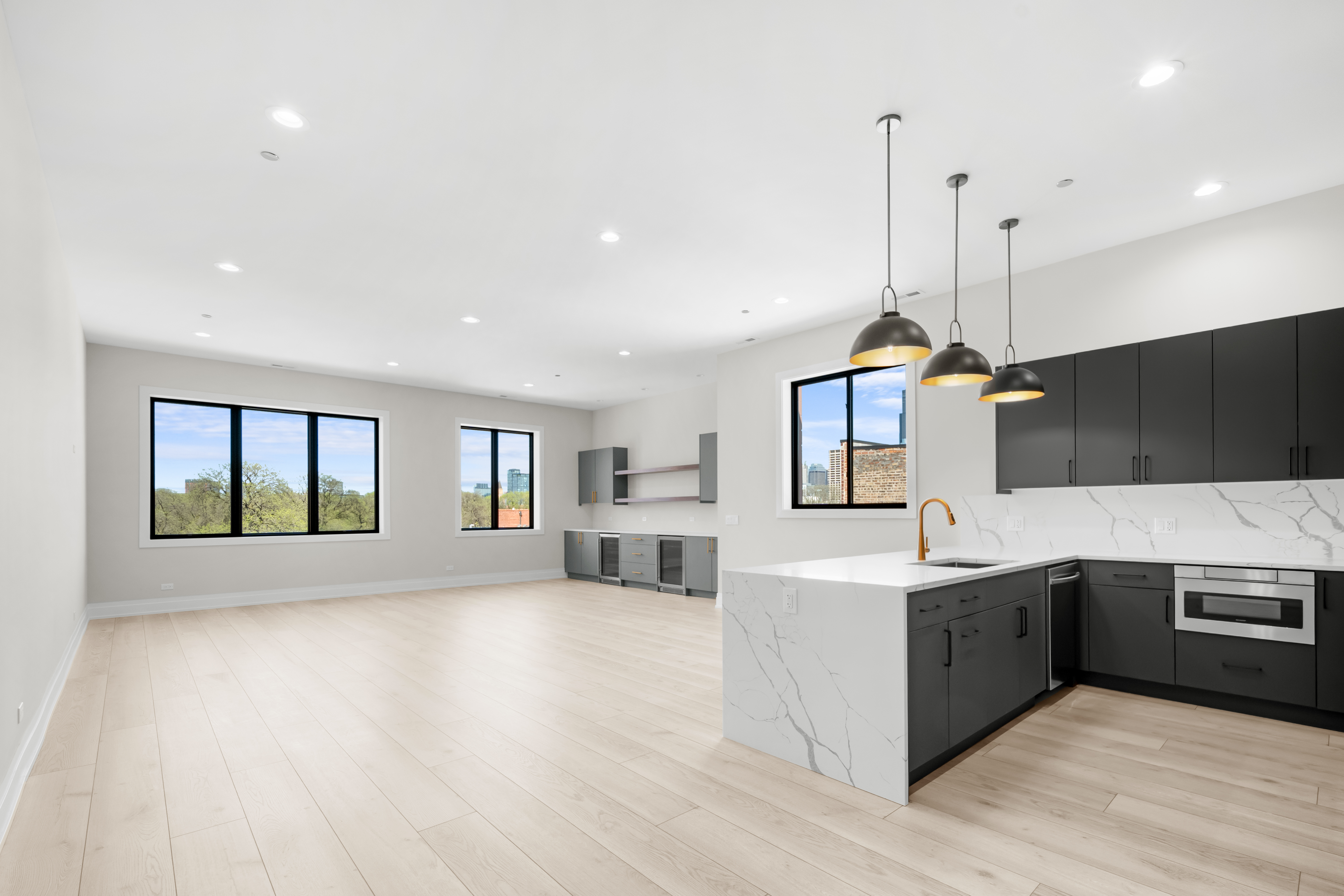 1327 West Taylor Street, Unit 4 Chicago, IL 60607 - Photo 5 of 27 a large kitchen with stainless steel appliances granite countertop a refrigerator a sink dishwasher a oven and a dining table with wooden floor