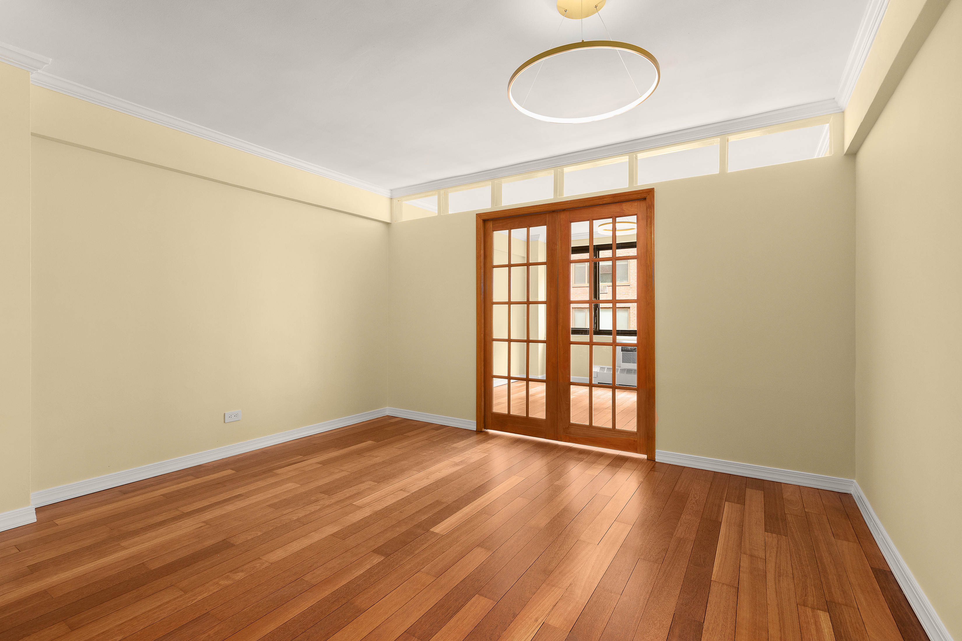 425 East 63rd Street, Unit E7A Manhattan, NY 10065 - Photo 8 of 13 an empty room with wooden floor and windows