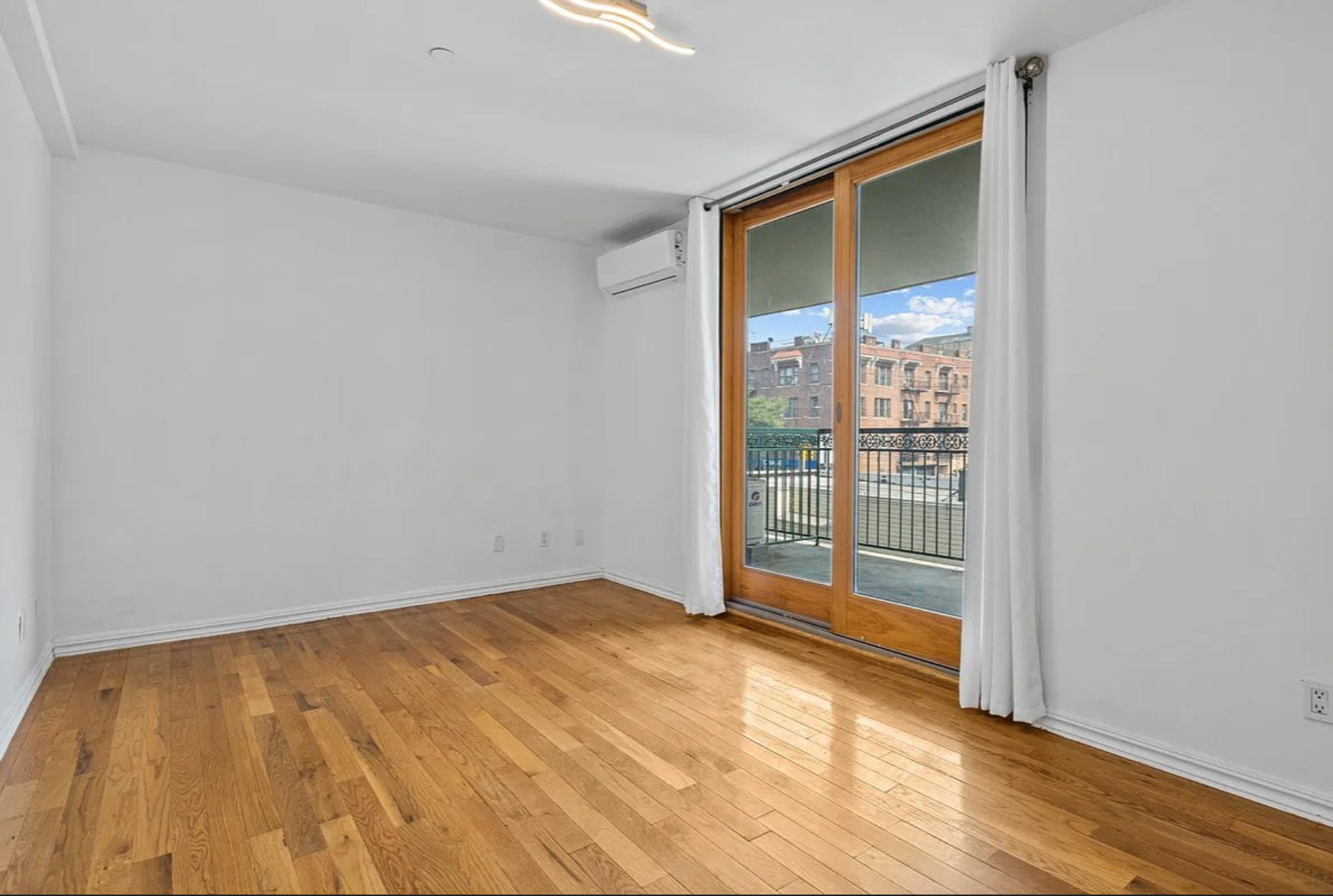 2882 West 15th Street, Unit 2B Brooklyn, NY 11224 - Photo 4 of 13 a view of an empty room and wooden floor