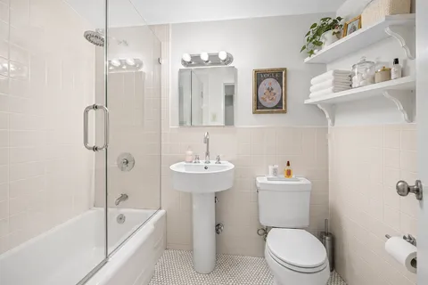 a bathroom with a sink toilet and shower